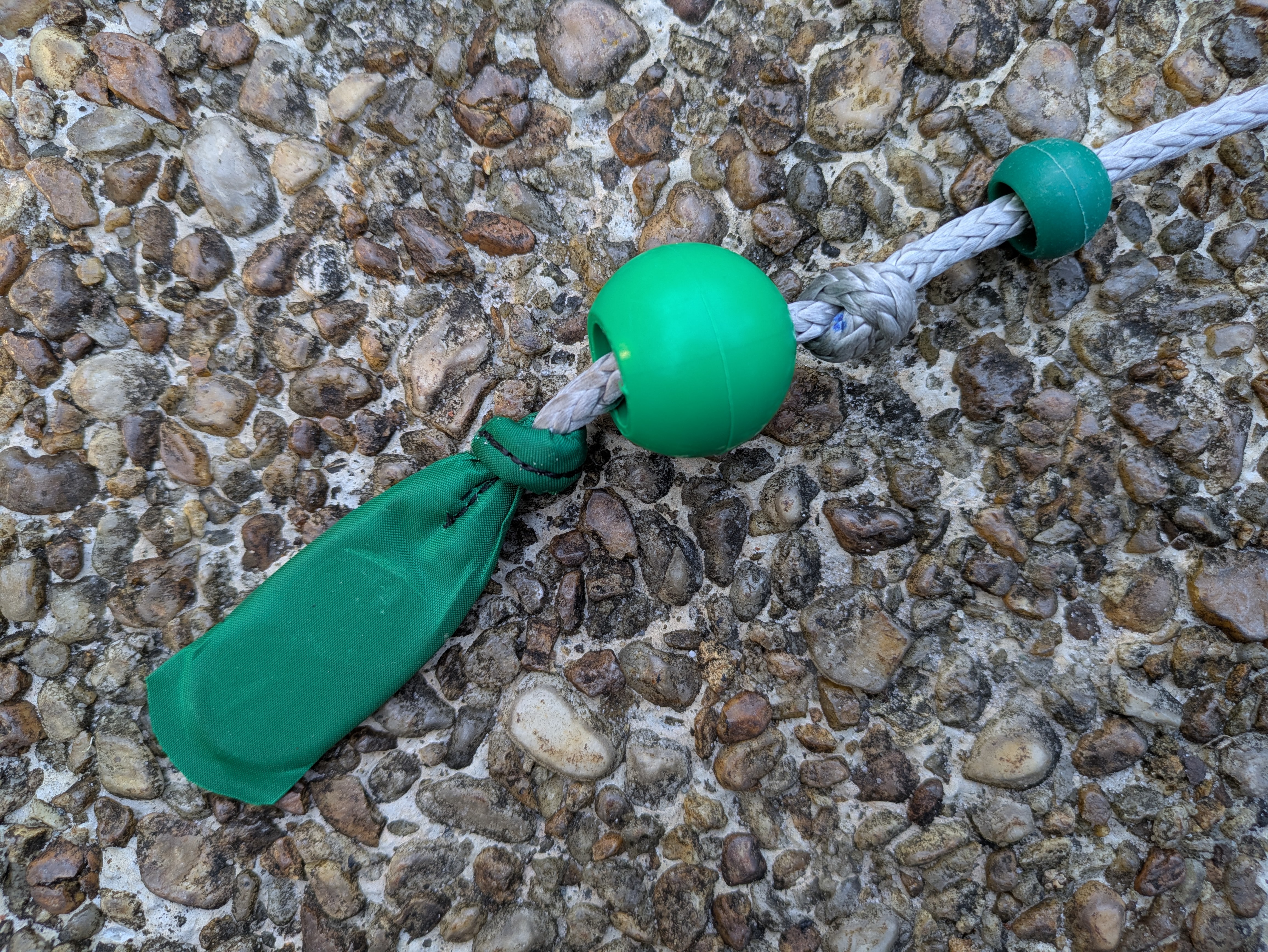 Grip end of the trim line with balls offset to show knots (above) and thread end (below)